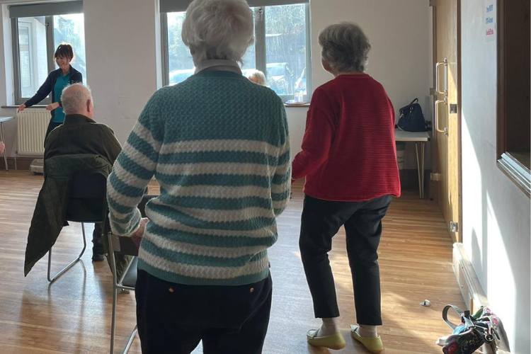 MOVEability Parkinson's UK exercise class in Berkshire - tapping out our feet whilst swinging arms, using dance to improve balance.