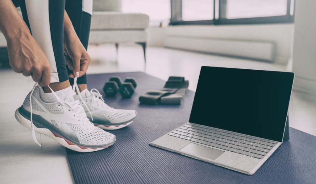 Person getting ready to do some low impact fitness online with a laptop