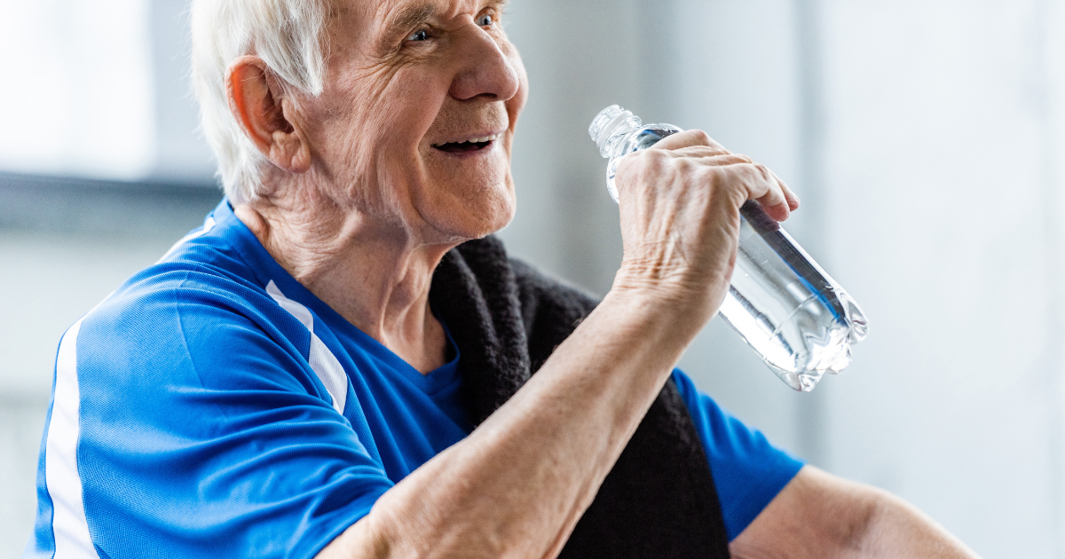 Senior man drinking water when exercising